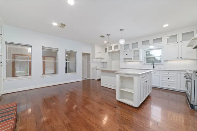a kitchen with white cabinets and white appliances