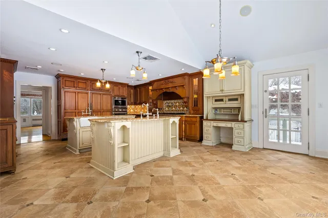 a kitchen with granite countertop a stove oven and a refrigerator
