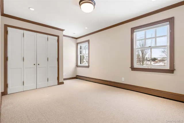 an empty room with windows and chandelier