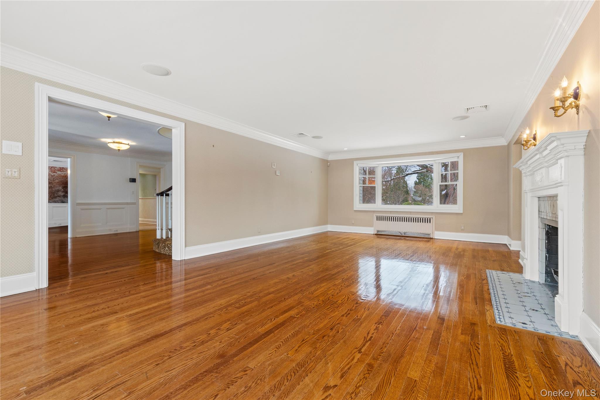 103 Pleasant Ridge Road Harrison, NY 10528 - Photo 4 of 39 a view of empty room with wooden floor and fireplace