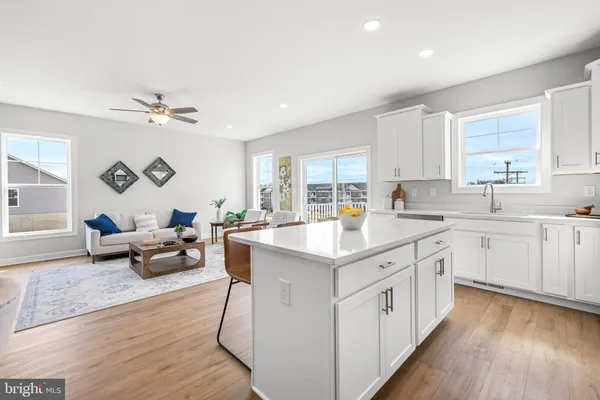 a kitchen with stainless steel appliances a refrigerator stove microwave and white cabinets