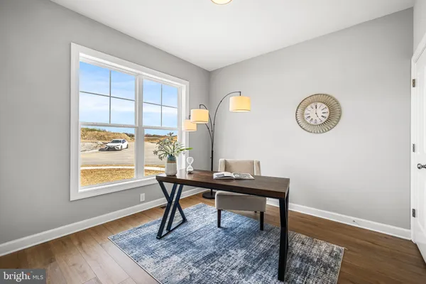 a view of a workspace with furniture and a window