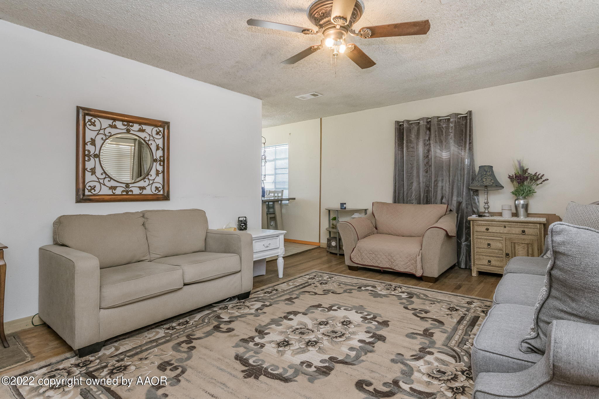 4409 South Travis Street Amarillo, TX 79110 - Photo 1 of 14 a living room with furniture and a chandelier