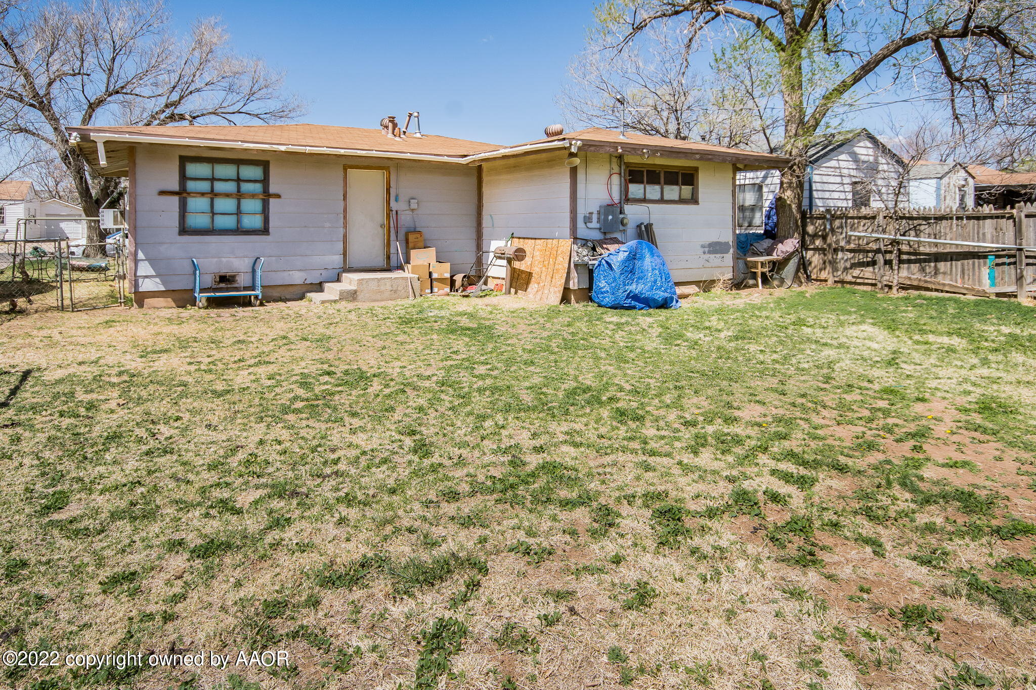 4409 South Travis Street Amarillo, TX 79110 - Photo 12 of 14 a view of a backyard with table and chairs under an umbrella