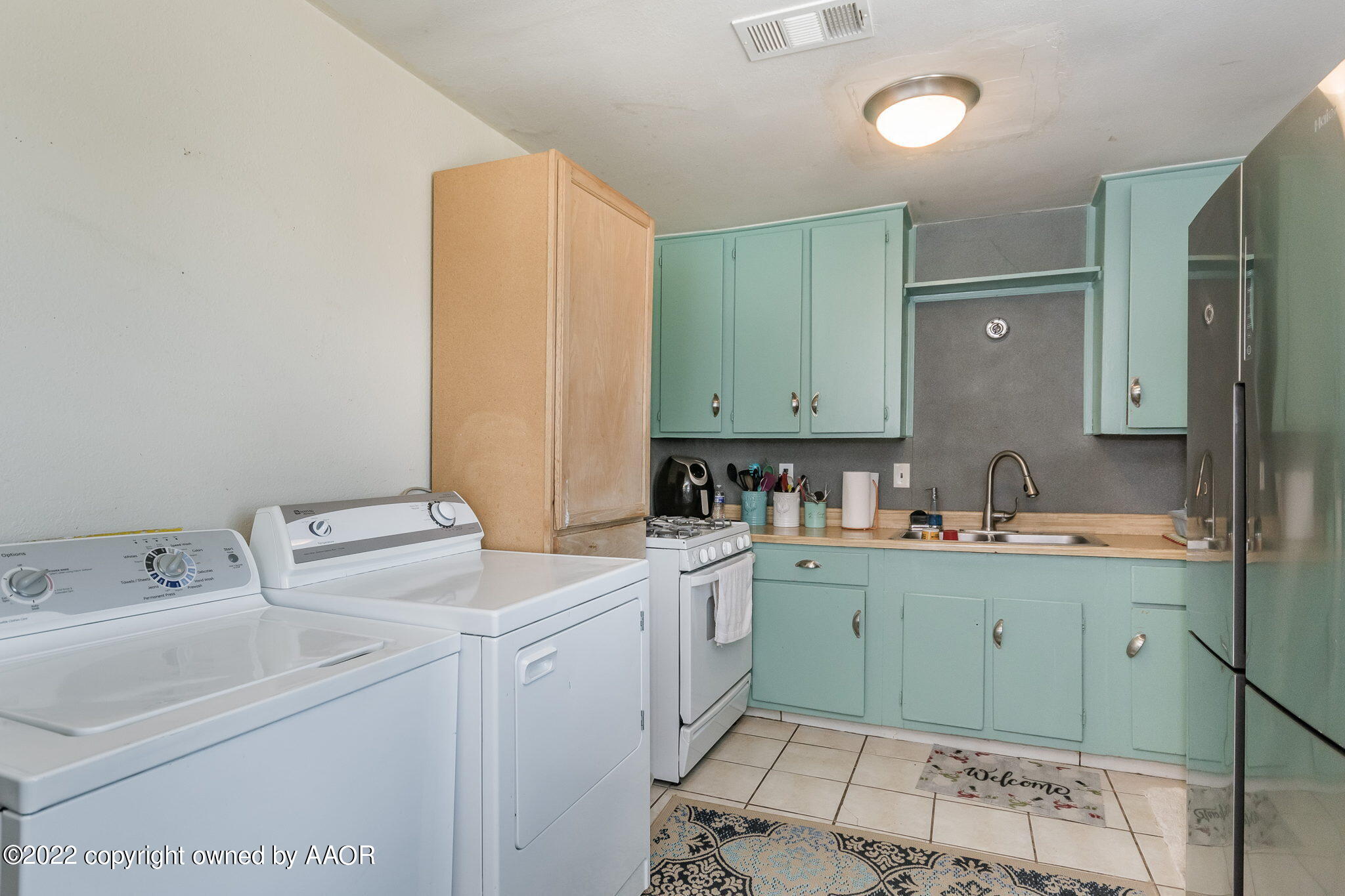 4409 South Travis Street Amarillo, TX 79110 - Photo 5 of 14 a room with a sink cabinets and utility room