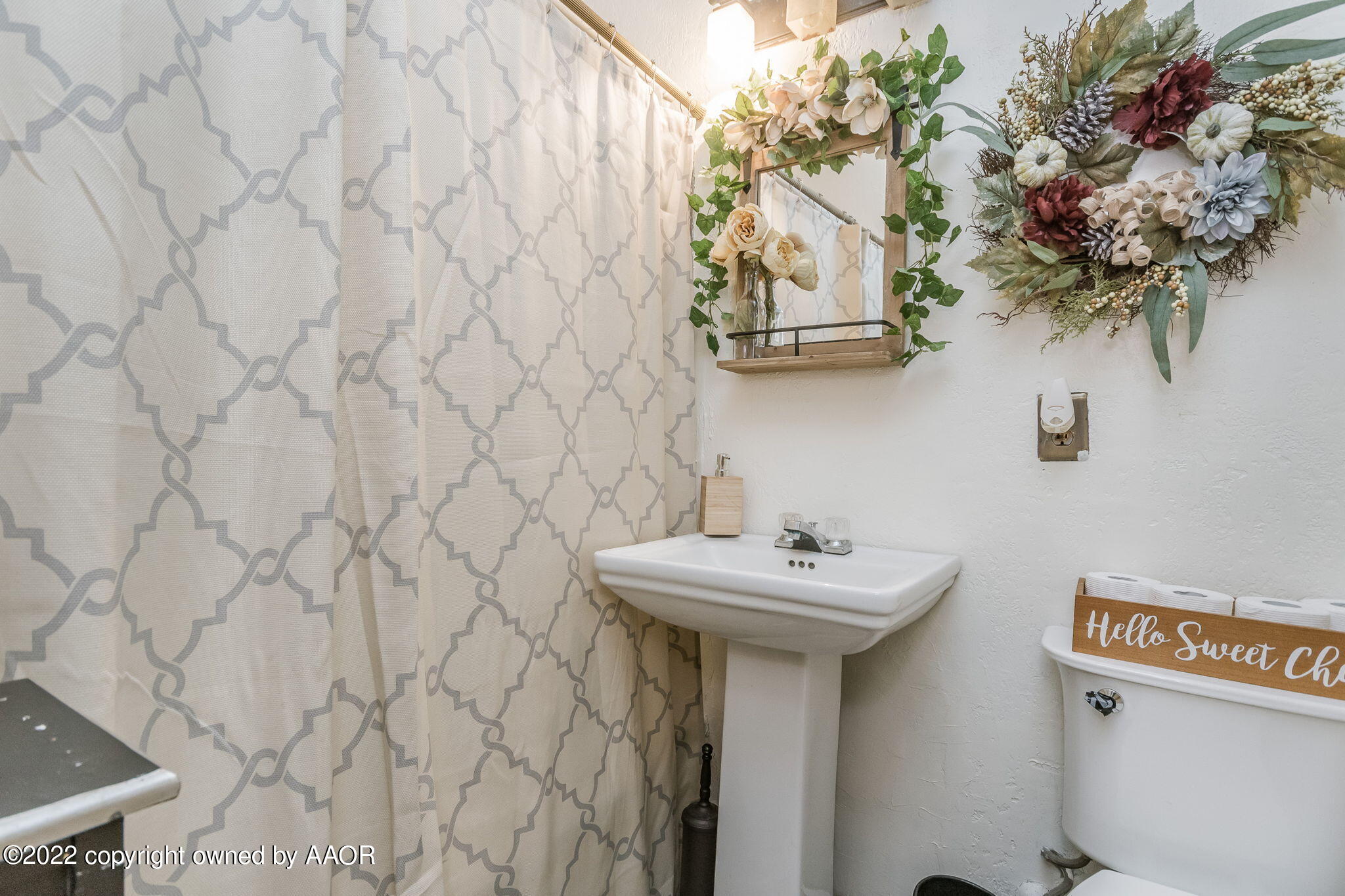 4409 South Travis Street Amarillo, TX 79110 - Photo 9 of 14 a bathroom with a sink and a mirror