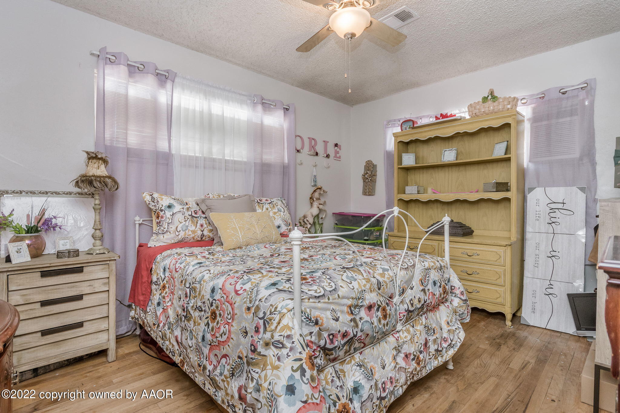 4409 South Travis Street Amarillo, TX 79110 - Photo 10 of 14 a bedroom with a bed and a chandelier
