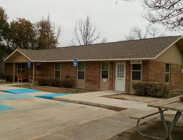 a front view of a house with yard fire pit and outdoor seating
