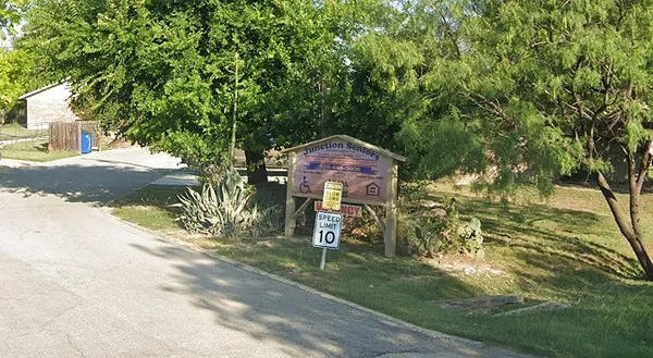 a pathway of a house with a yard