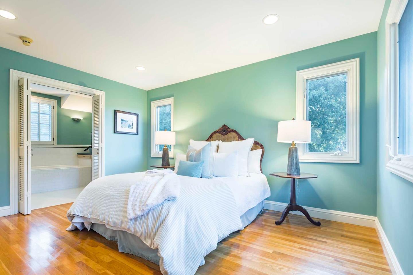 11491 Old Ranch Road Los Altos Hills, CA 94024 - Photo 36 of 52 a bedroom with a bed and a lamp on table