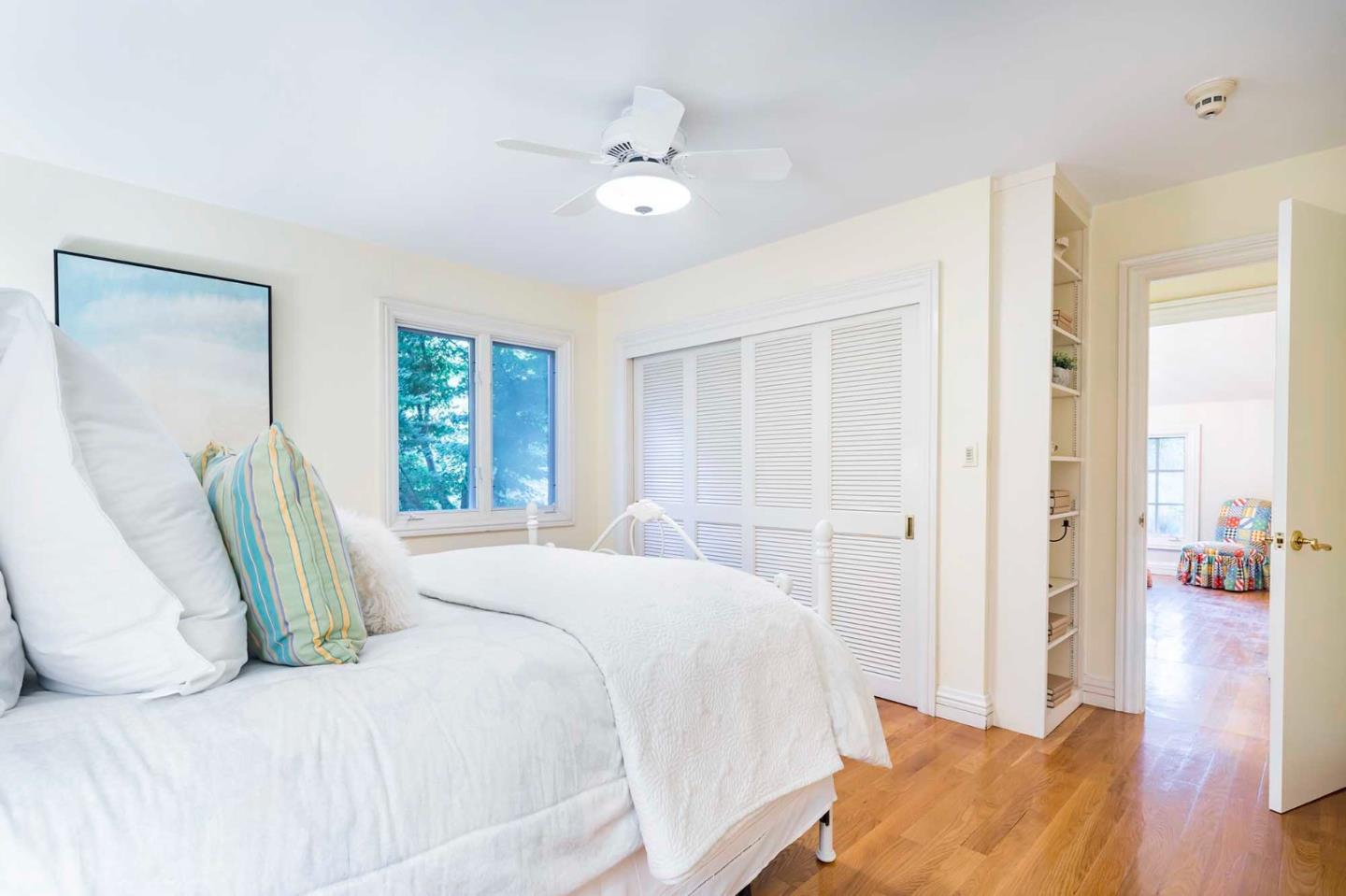 11491 Old Ranch Road Los Altos Hills, CA 94024 - Photo 38 of 52 a bedroom with a bed and wooden floor