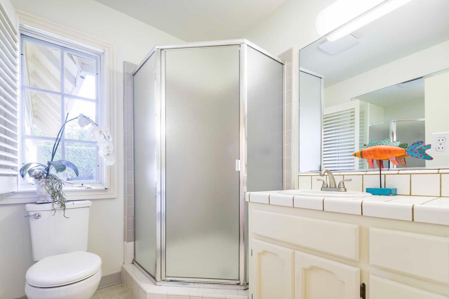 11491 Old Ranch Road Los Altos Hills, CA 94024 - Photo 47 of 52 a bathroom with a sink and a mirror