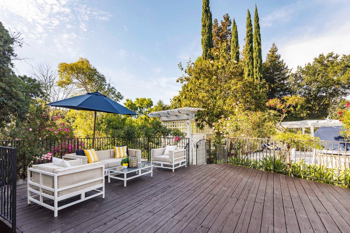 11491 Old Ranch Road Los Altos Hills, CA 94024 - Photo 5 of 52 a backyard of a house with table and chairs