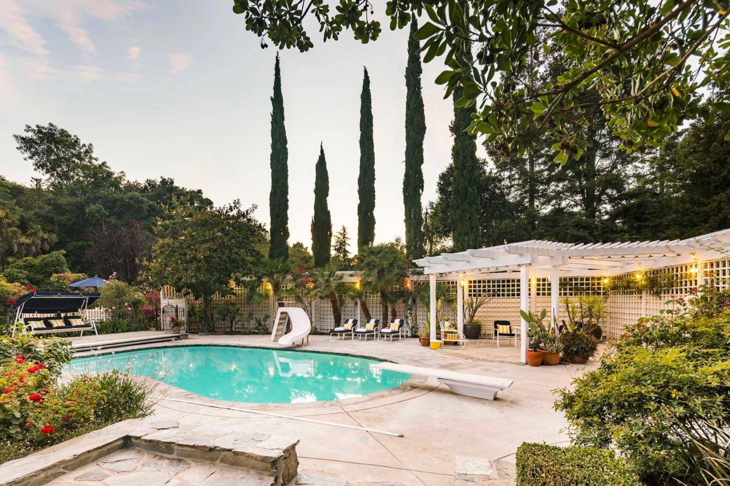 11491 Old Ranch Road Los Altos Hills, CA 94024 - Photo 6 of 52 a front view of a house with a yard and trees