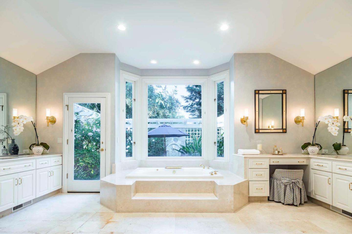 11491 Old Ranch Road Los Altos Hills, CA 94024 - Photo 10 of 52 a spacious bathroom with a double vanity sink a large mirror and bathtub