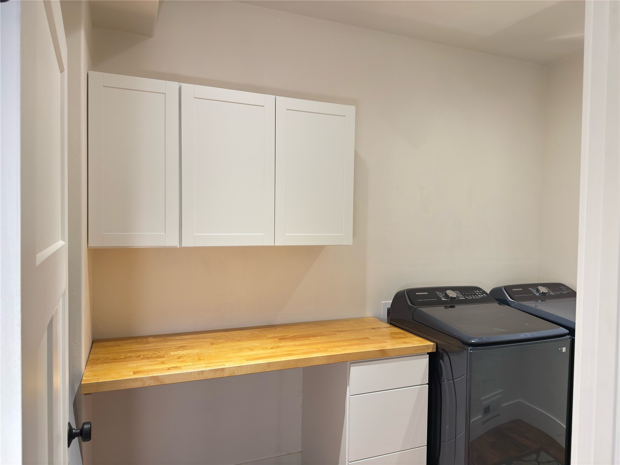 717 Icehouse Road Whitefish, MT 59937 - Photo 23 of 31 Laundry room featuring cabinet space, a desk, and washer and dryer