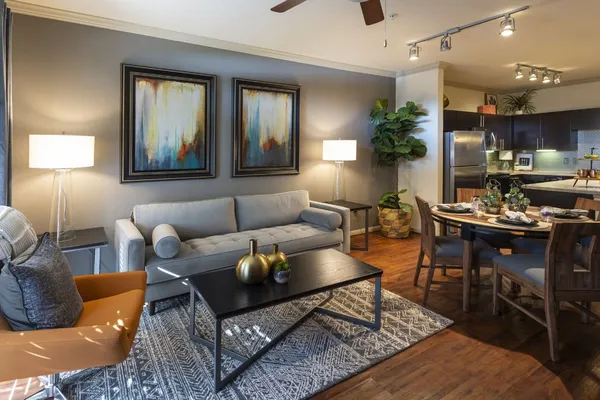 a living room with furniture and wooden floor