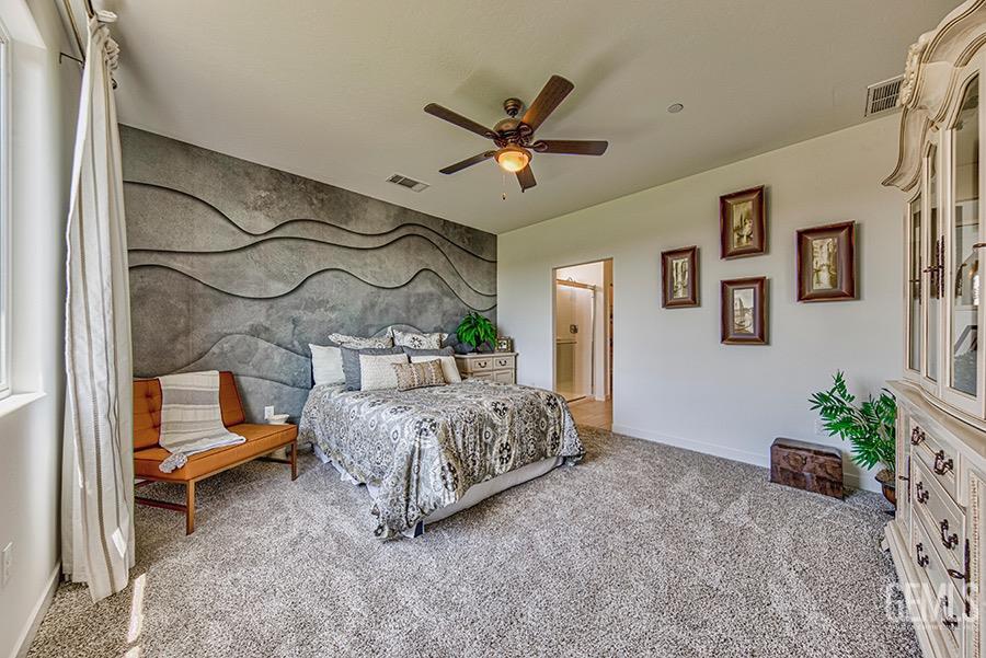 Undisclosed Address Bakersfield, CA 93311 - Photo 4 of 11 a bedroom with a bed and a chandelier