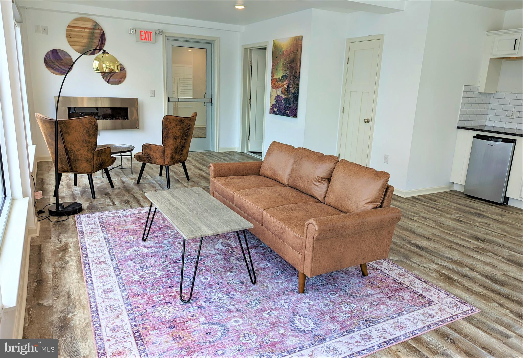6649 Ridge Avenue, Unit B103 Philadelphia, PA 19128 - Photo 12 of 14 a living room with furniture and a rug