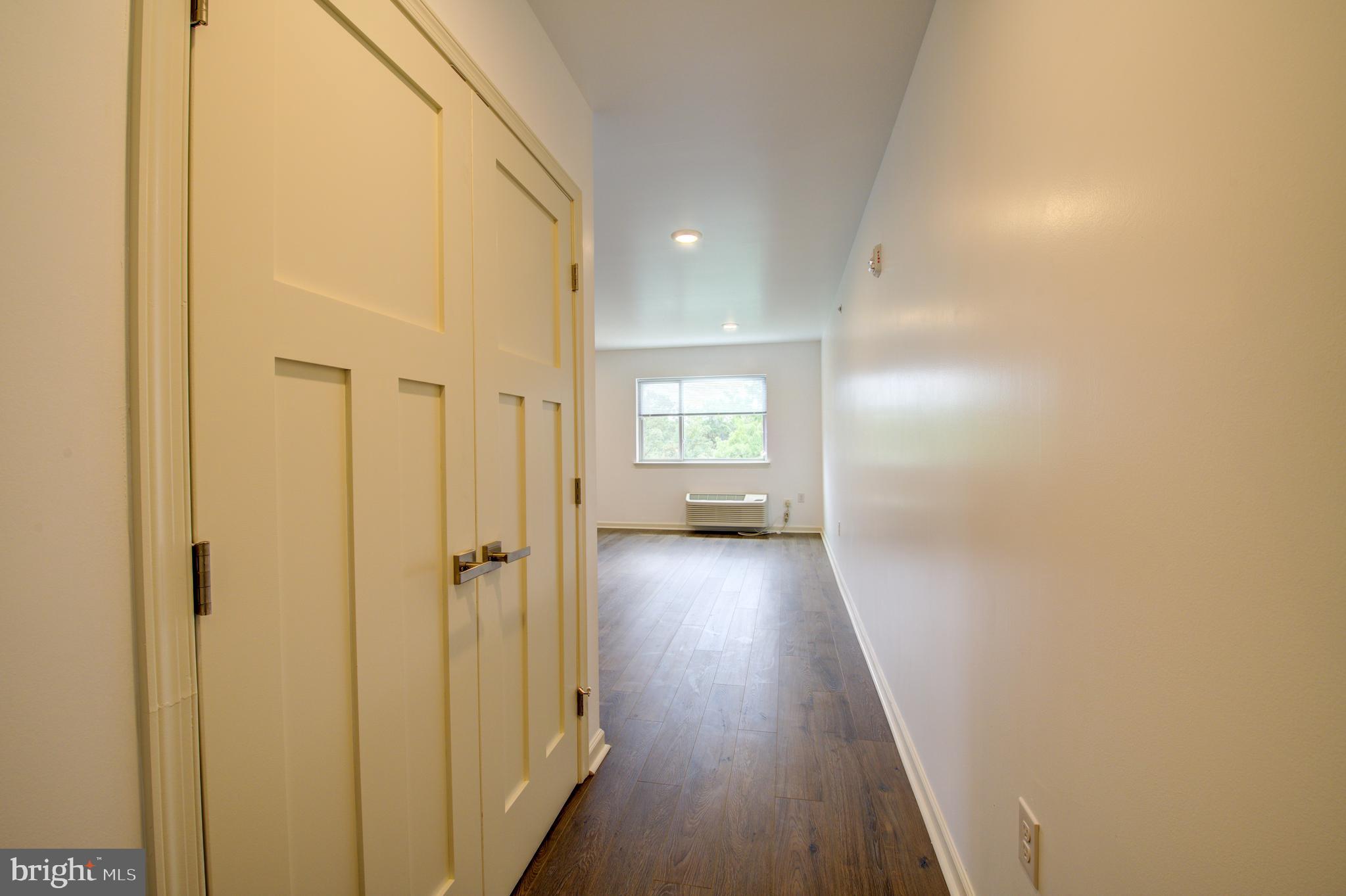 6649 Ridge Avenue, Unit B103 Philadelphia, PA 19128 - Photo 2 of 14 a view of a hallway with wooden floor