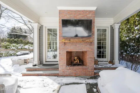 a living room with a fireplace and a large window