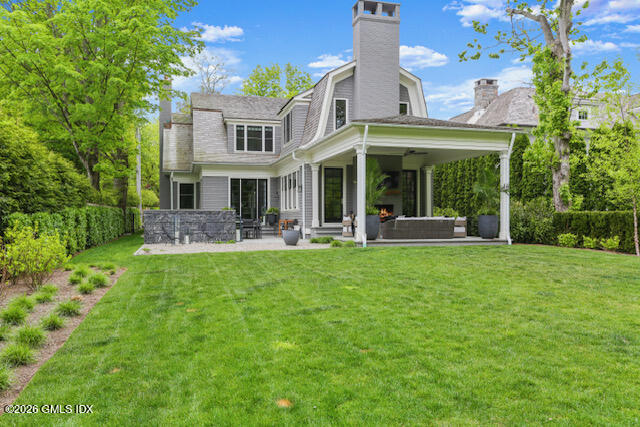 7 Indian Head Road Riverside, CT 06878 - Photo 5 of 7 a front view of a house with a yard table and chairs