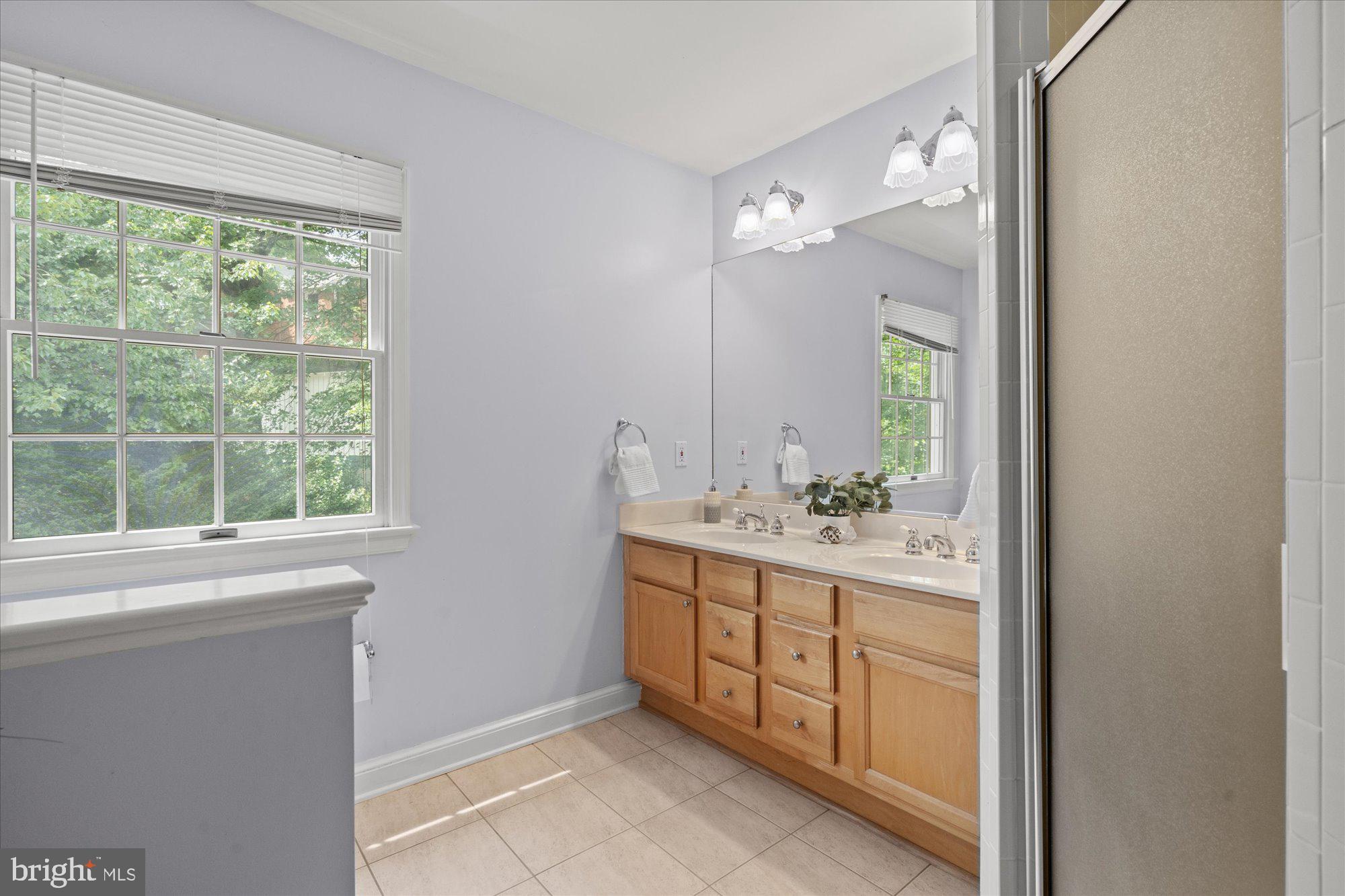 9500 Columbia Boulevard Silver Spring, MD 20910 - Photo 13 of 19 Hall bath with a double vanity, walk-in shower