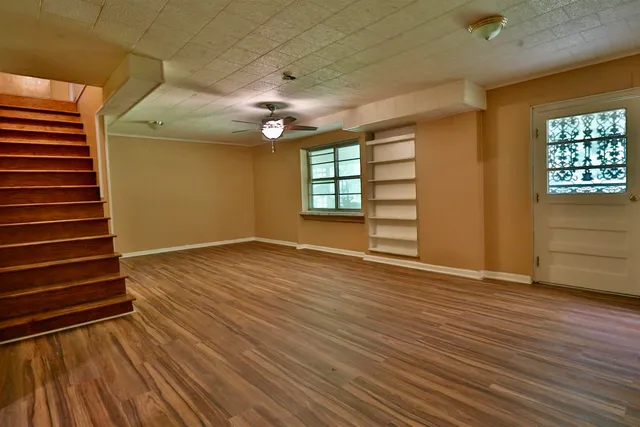 wooden floor in an empty room with a window