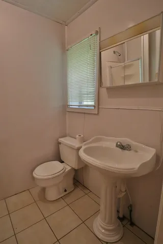 a view of a room with wooden floor and a ceiling fan