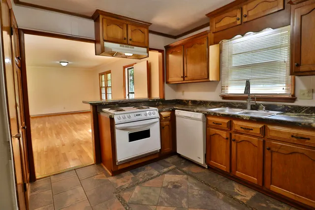 a kitchen with a stove a sink and a microwave