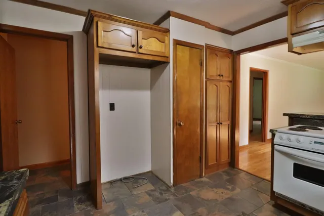 a kitchen with stainless steel appliances granite countertop a sink and a stove with wooden floor