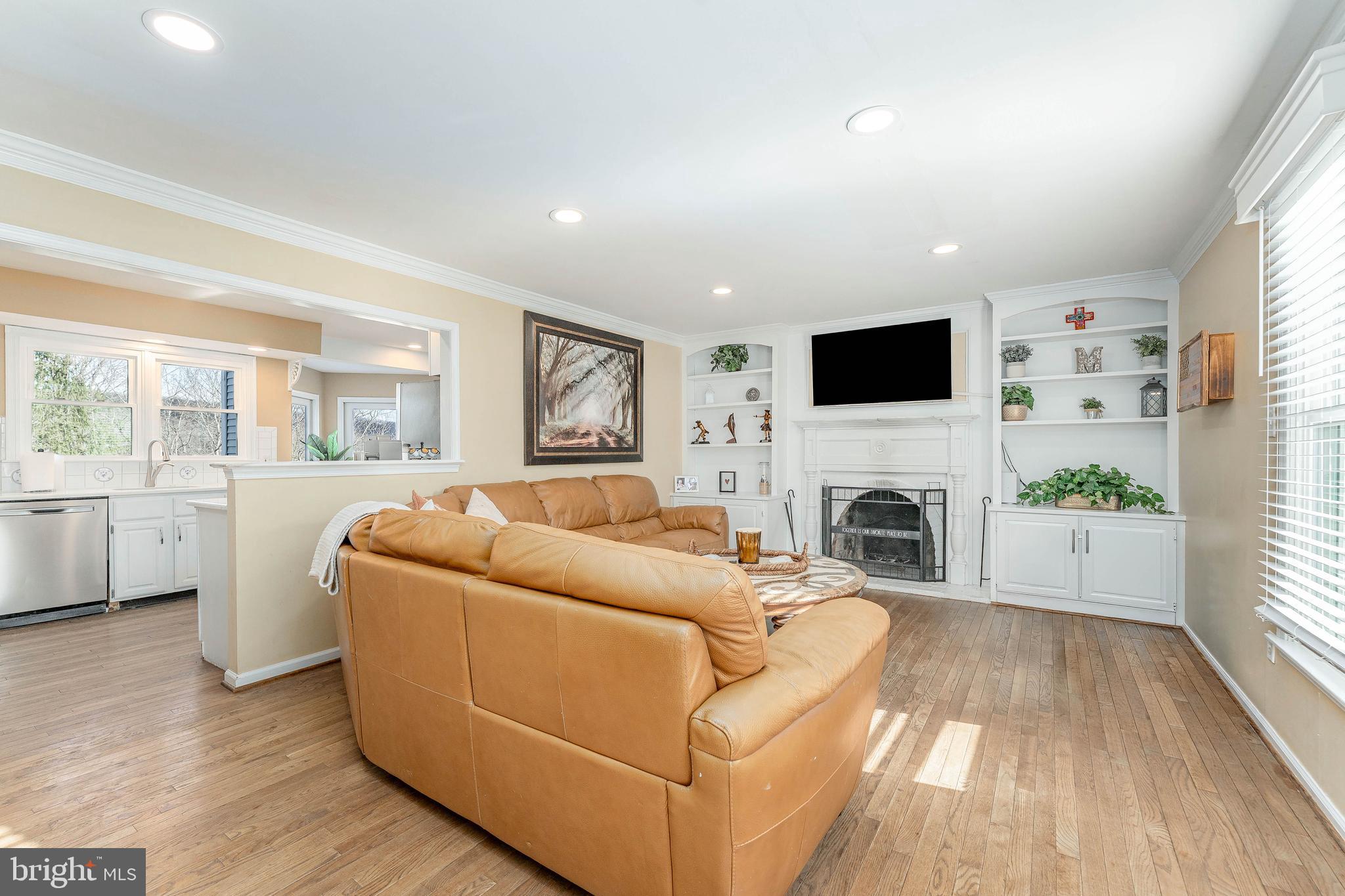 8 Matthews Run Road Chester Springs, PA 19425 - Photo 12 of 80 a living room with furniture a fireplace and a flat screen tv