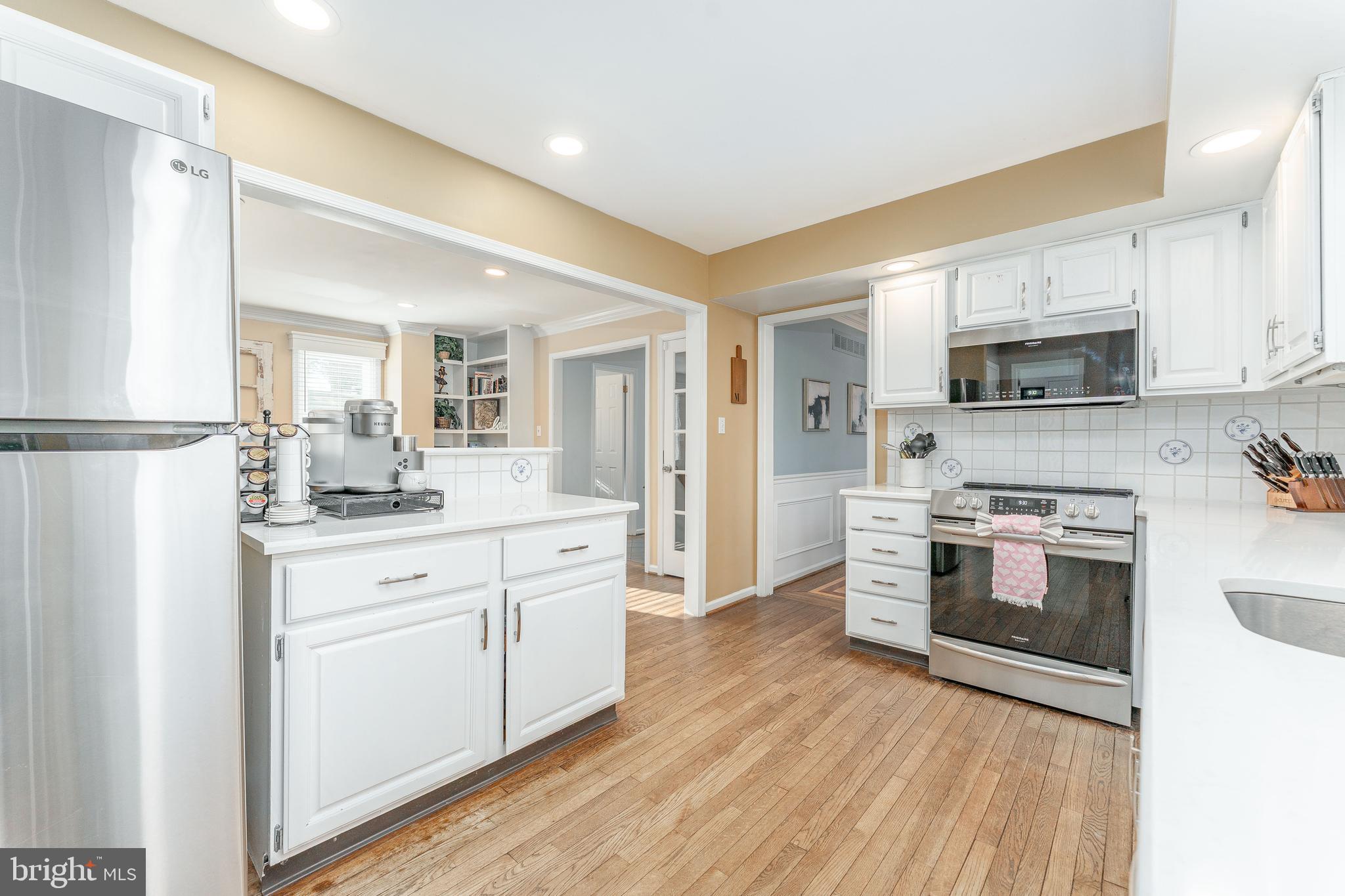 8 Matthews Run Road Chester Springs, PA 19425 - Photo 17 of 80 a kitchen with stainless steel appliances a stove top oven a sink and a refrigerator