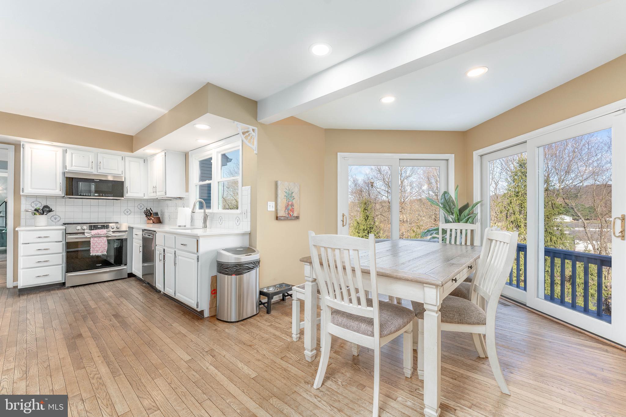 8 Matthews Run Road Chester Springs, PA 19425 - Photo 21 of 80 a view of a dining room with furniture a kitchen and chandelier