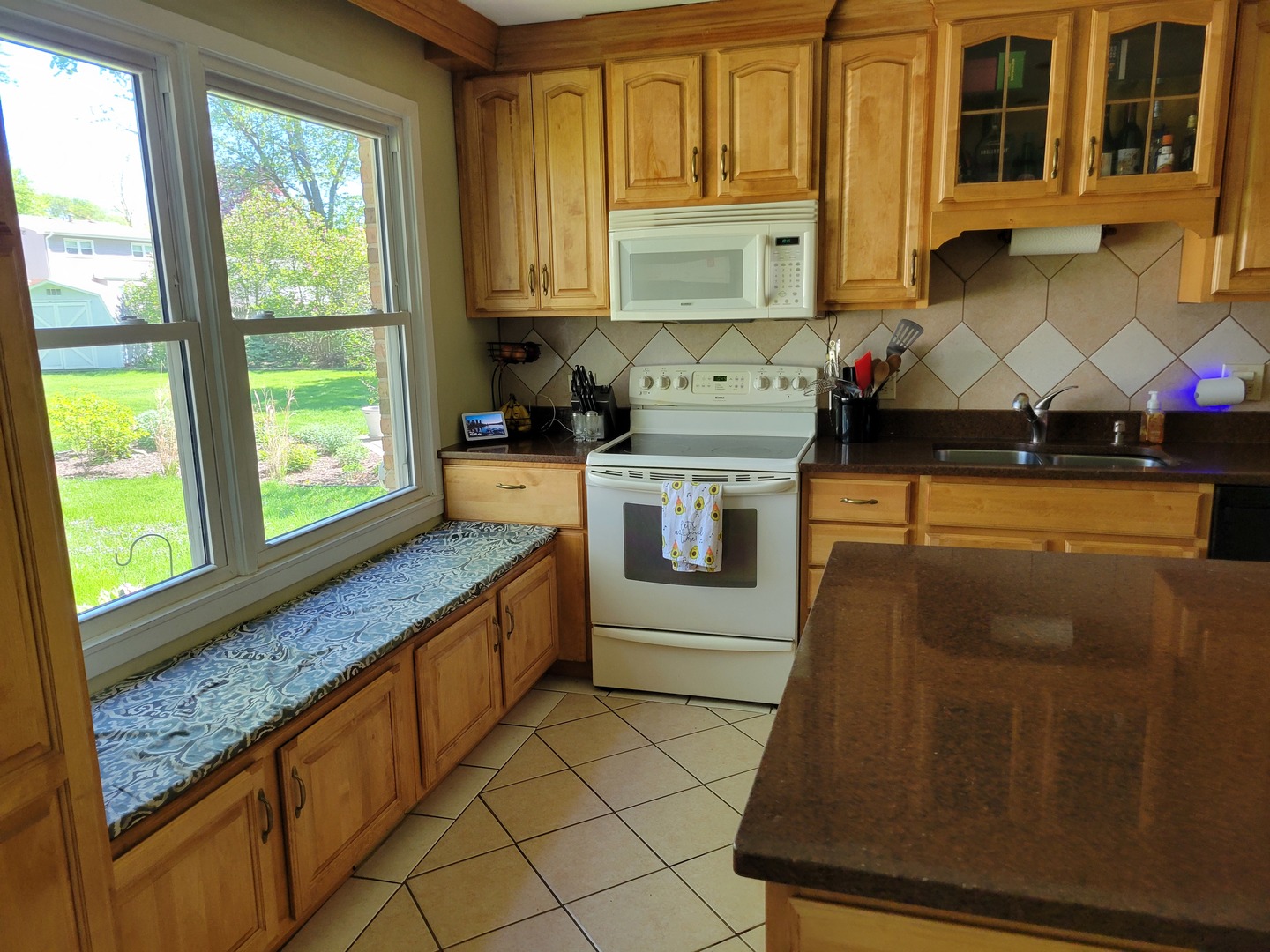 1322 Elder Road Homewood, IL 60430 - Photo 13 of 27 a kitchen with stainless steel appliances granite countertop a stove a sink and a microwave