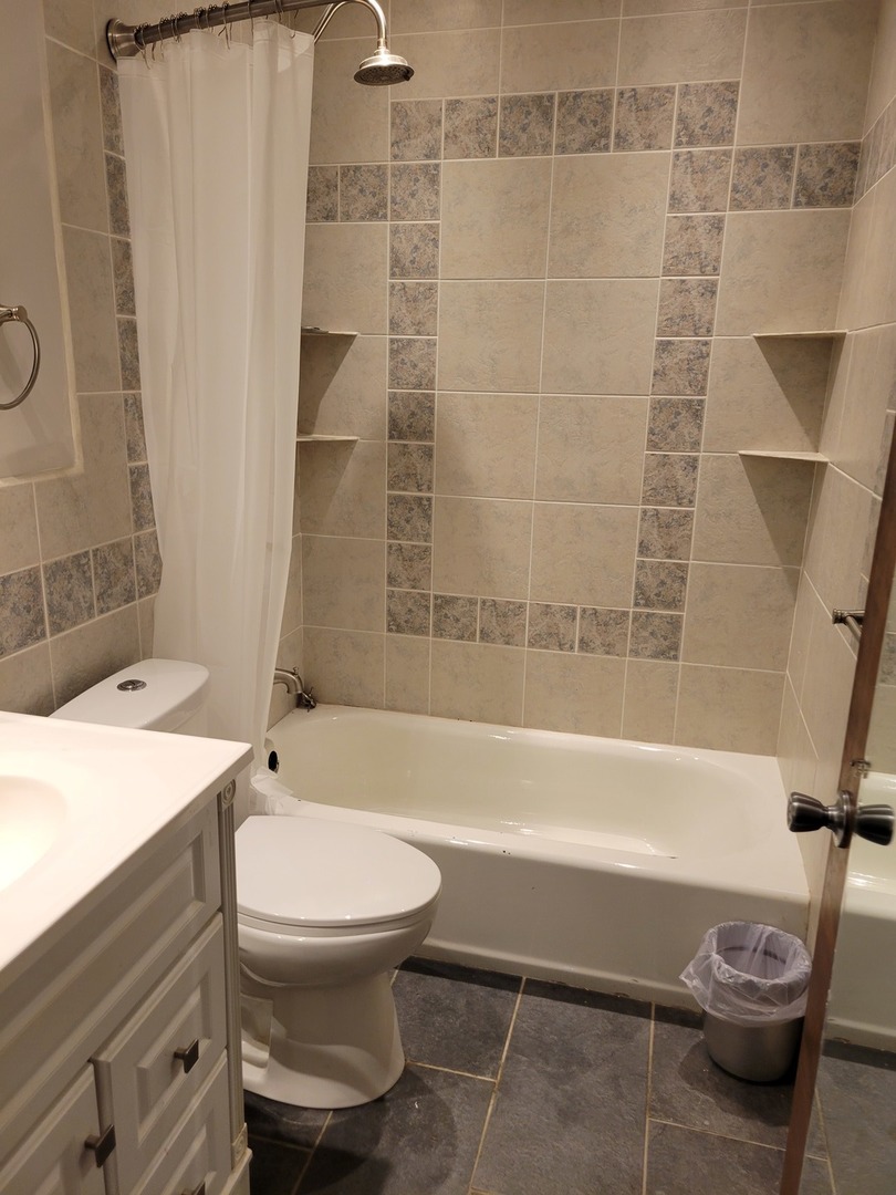 1322 Elder Road Homewood, IL 60430 - Photo 23 of 27 a bathroom with a toilet and a bathtub