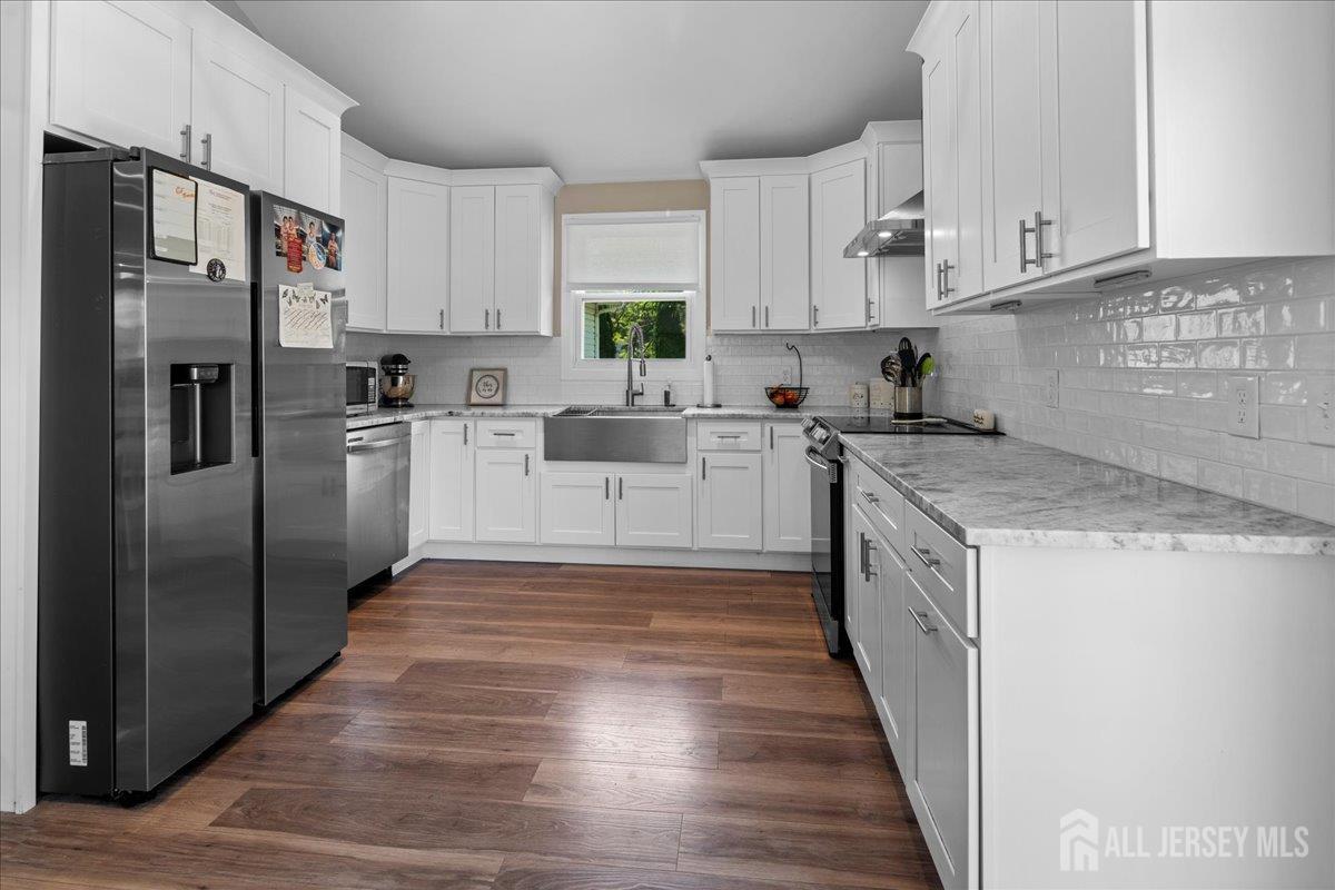 5 Applegate Road Jobstown, NJ 08041 - Photo 7 of 34 a kitchen with stainless steel appliances granite countertop a refrigerator a stove a sink and white cabinets