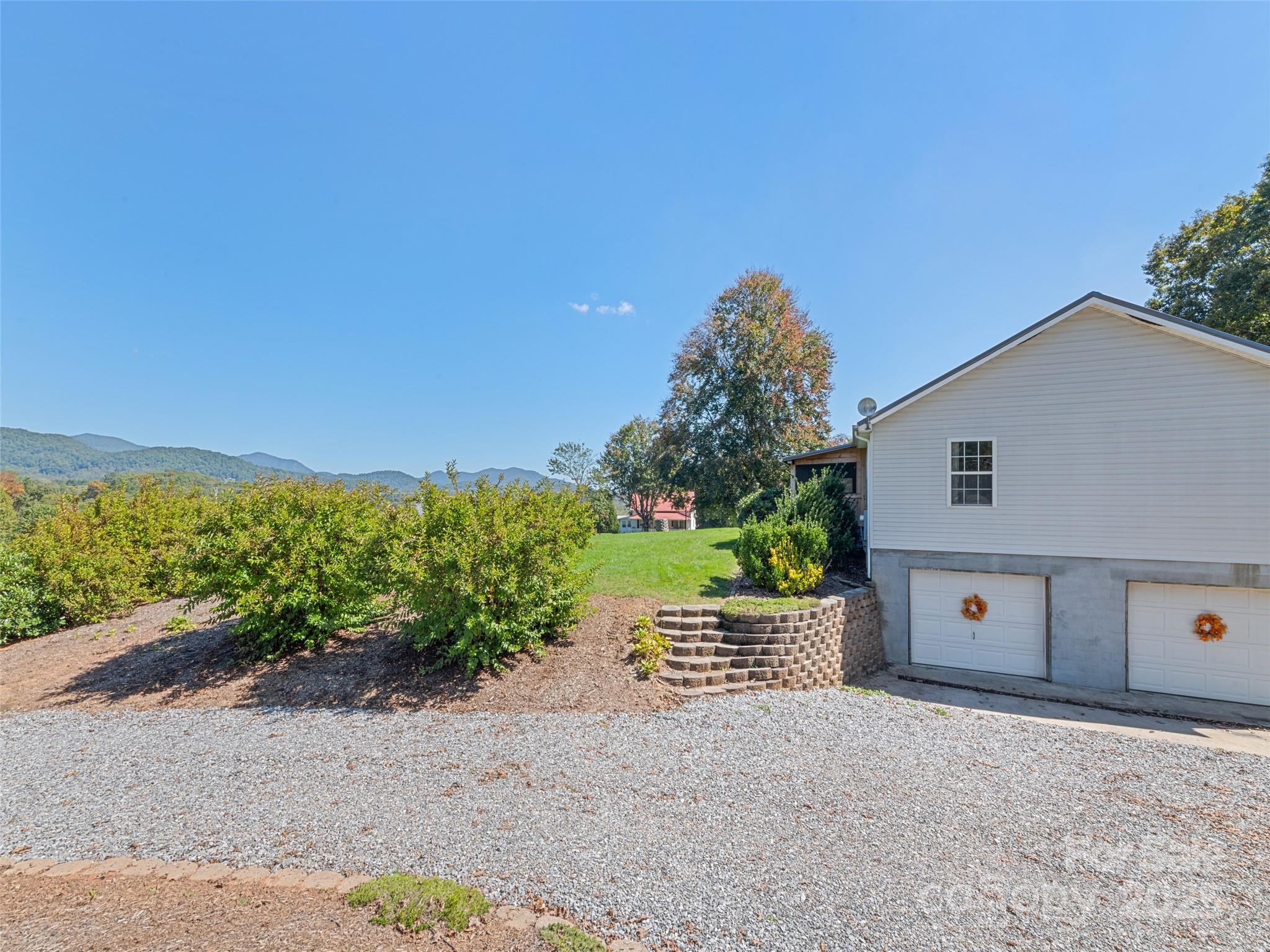 2884 Thickety Road Clyde, NC 28721 - Photo 1 of 20 a view of a house with a yard and a large parking space