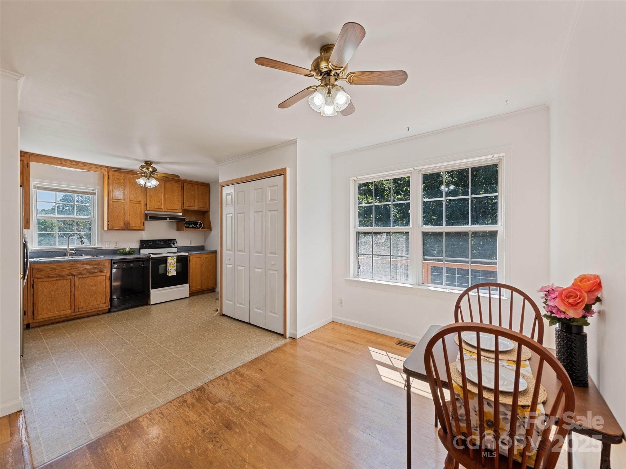 2884 Thickety Road Clyde, NC 28721 - Photo 11 of 20 a kitchen with stainless steel appliances kitchen island granite countertop a refrigerator a stove a sink with a dining table and chairs with wooden floor