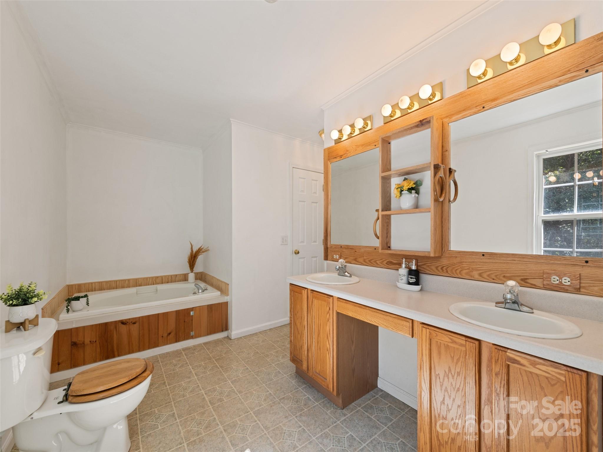 2884 Thickety Road Clyde, NC 28721 - Photo 16 of 20 a bathroom with a double vanity sink toilet and mirror
