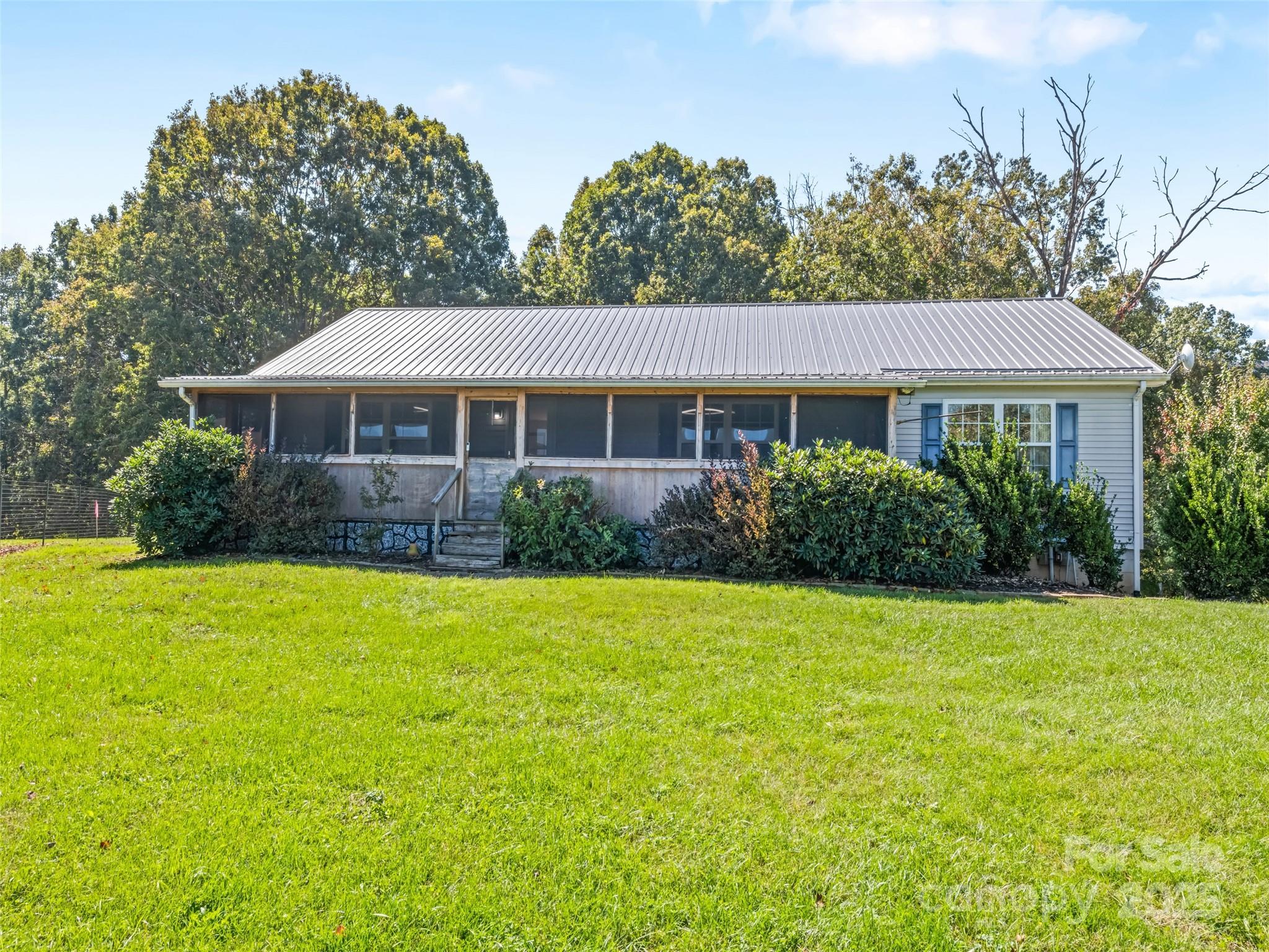 2884 Thickety Road Clyde, NC 28721 - Photo 4 of 20 a front view of a house with a yard and trees