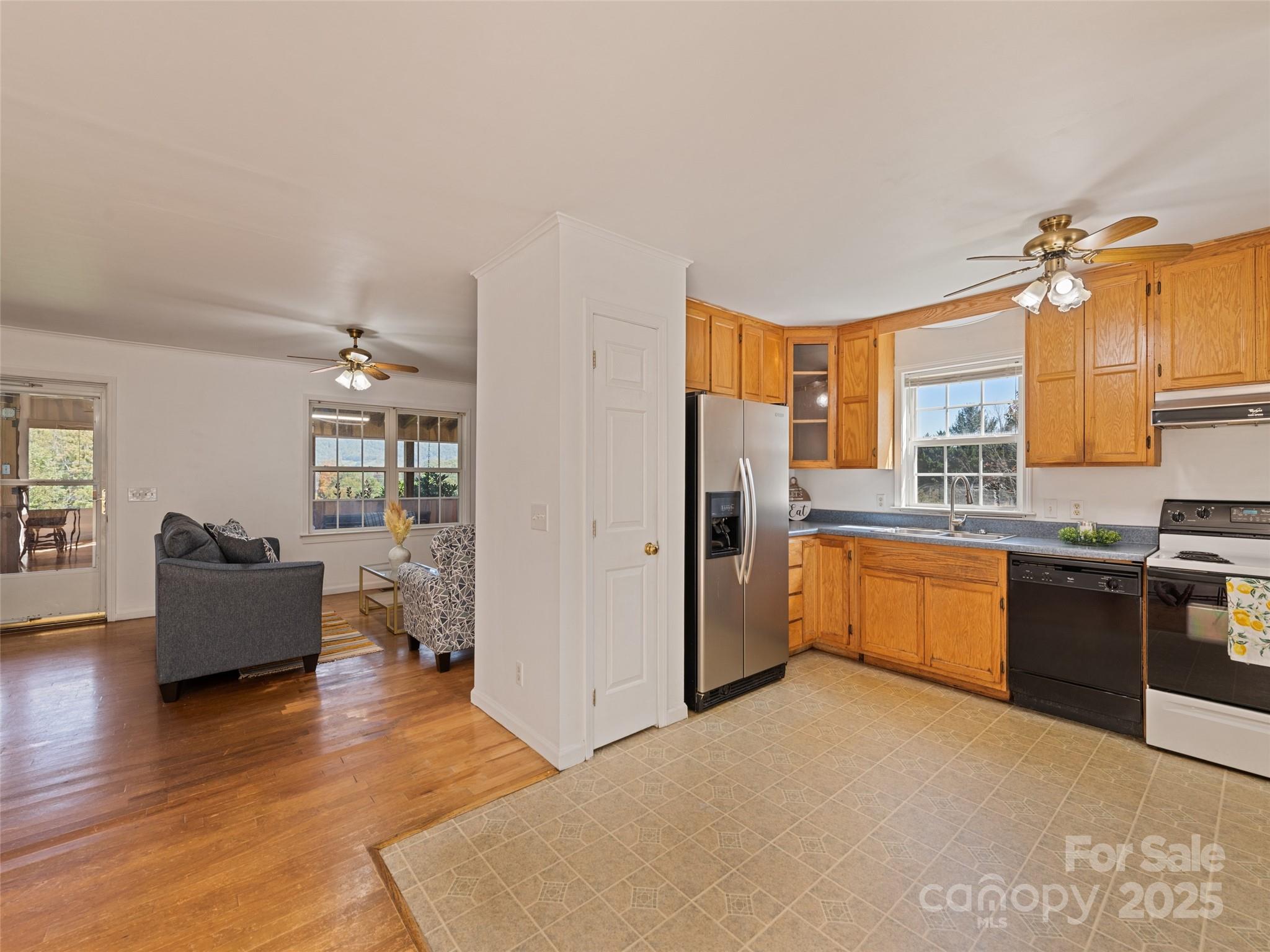 2884 Thickety Road Clyde, NC 28721 - Photo 10 of 20 a large kitchen with stainless steel appliances granite countertop a refrigerator a stove top oven a sink dishwasher and wooden cabinets