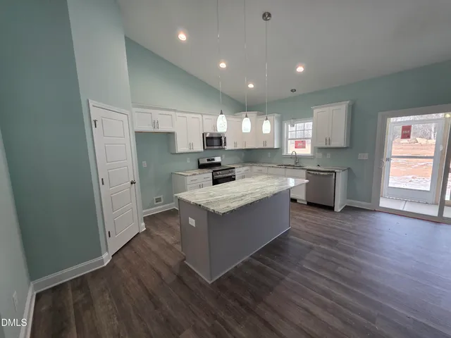 a kitchen with a sink a counter top space and stainless steel appliances