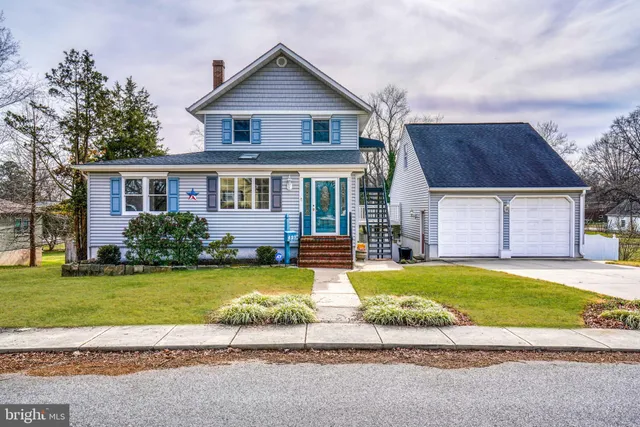a view of a house with a swimming pool and a yard with trees