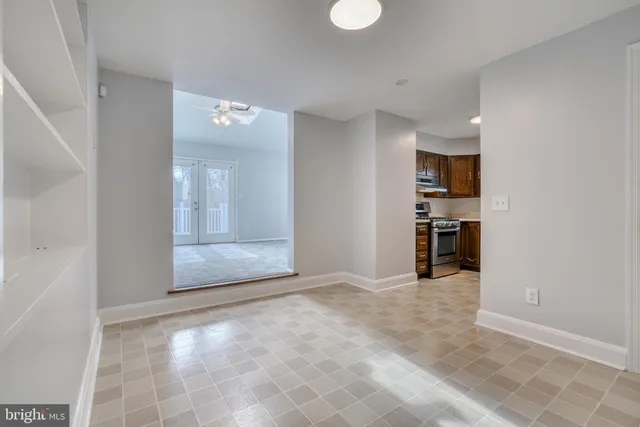 an empty room with windows and closet