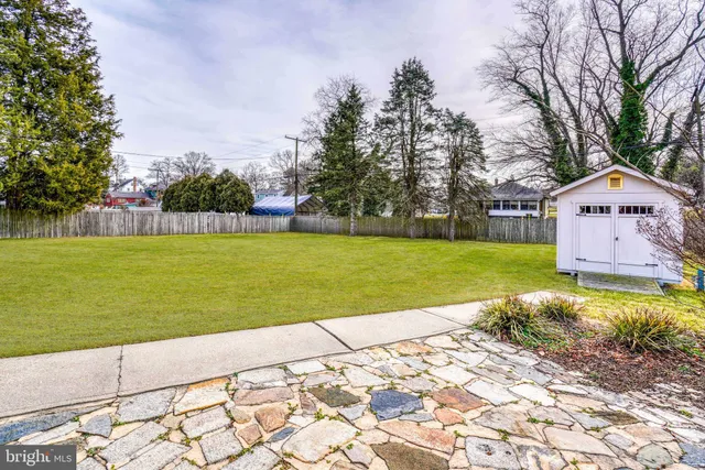 a front view of house with backyard and trees