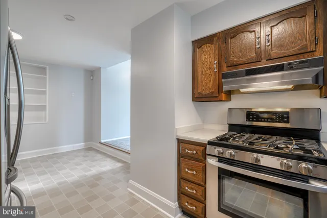 a kitchen with stainless steel appliances granite countertop a stove and a refrigerator
