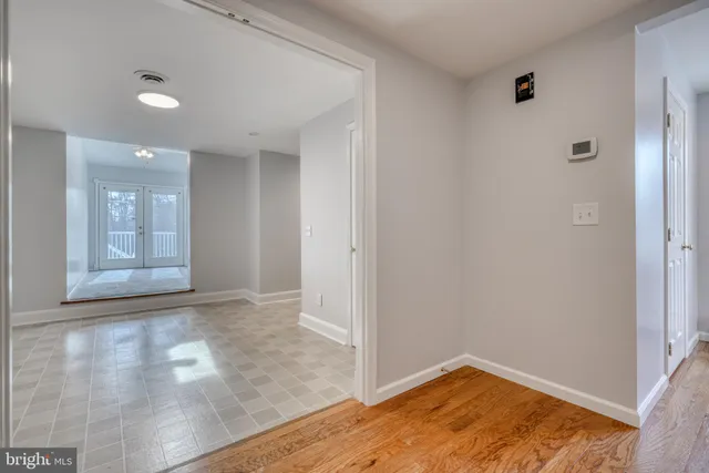 a view of kitchen with refrigerator and window