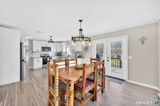 a view of a dining room with furniture window and wooden floor