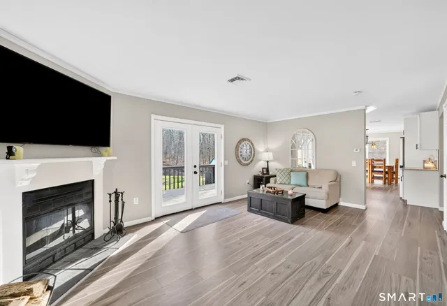 a living room with furniture a fireplace and a flat screen tv